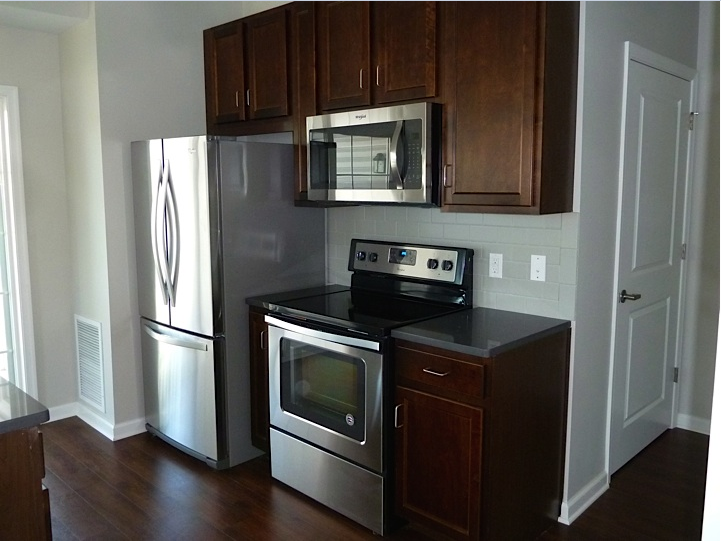 a kitchen with stainless steel appliances and wooden cabinets