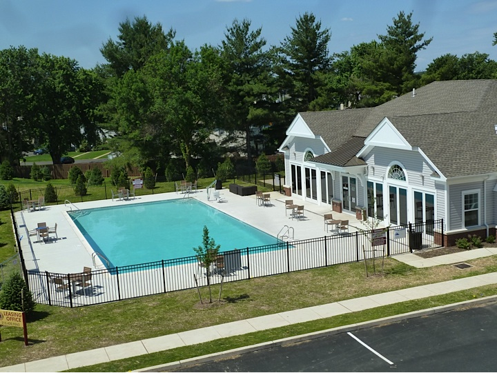 a large swimming pool in front of a house