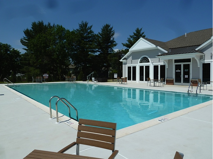 a large swimming pool in front of a house