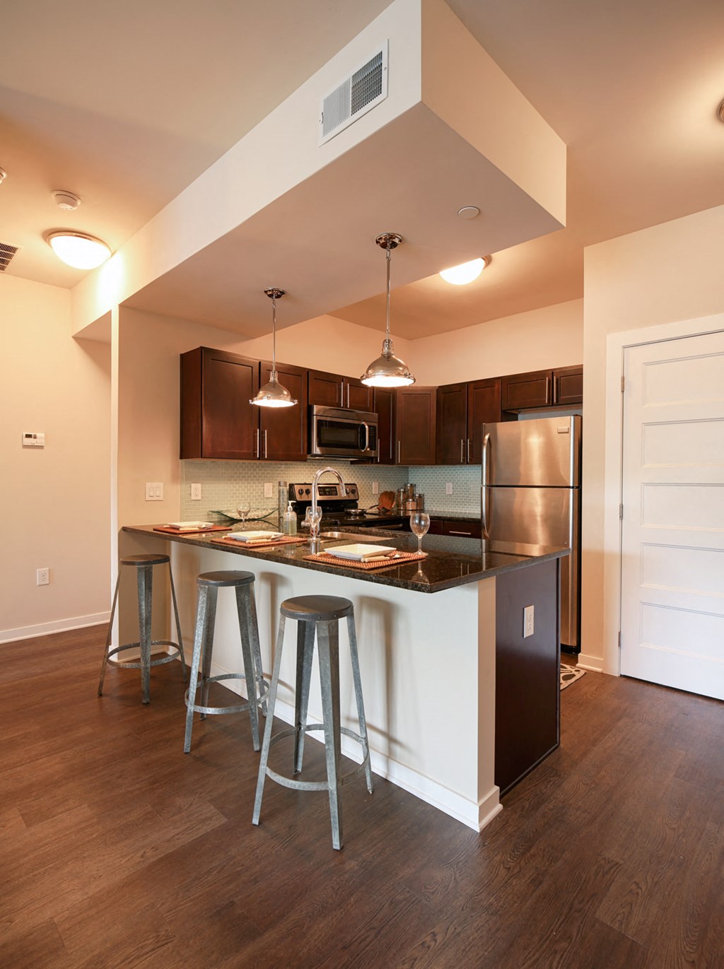 a kitchen with a bar and stools