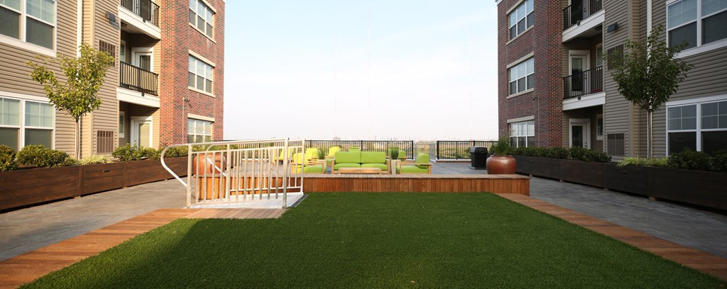 a rendering of an apartment balcony with turf and grass