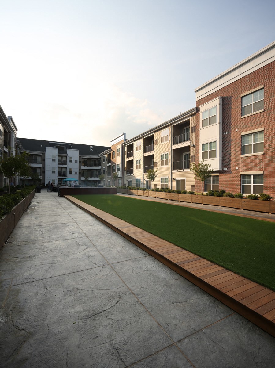 a view of the courtyard of an apartment building with grass