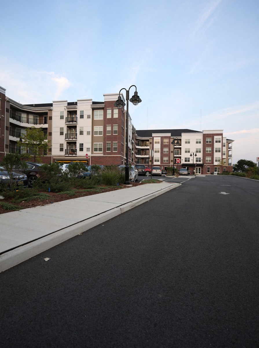 an empty street with apartment buildings on the side of it