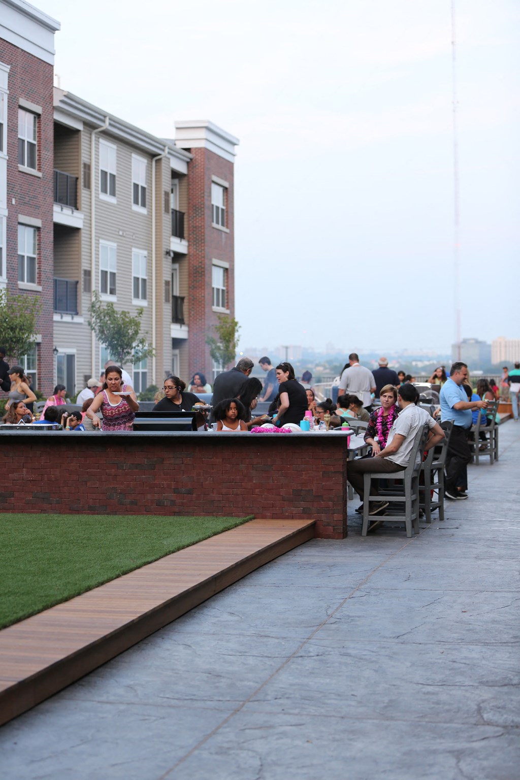 people sitting at tables outside of an apartment building