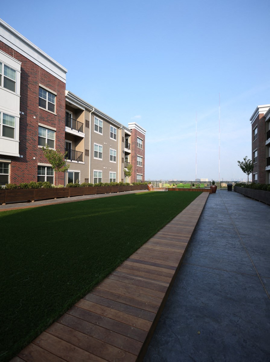 a walkway in front of a row of apartment buildings