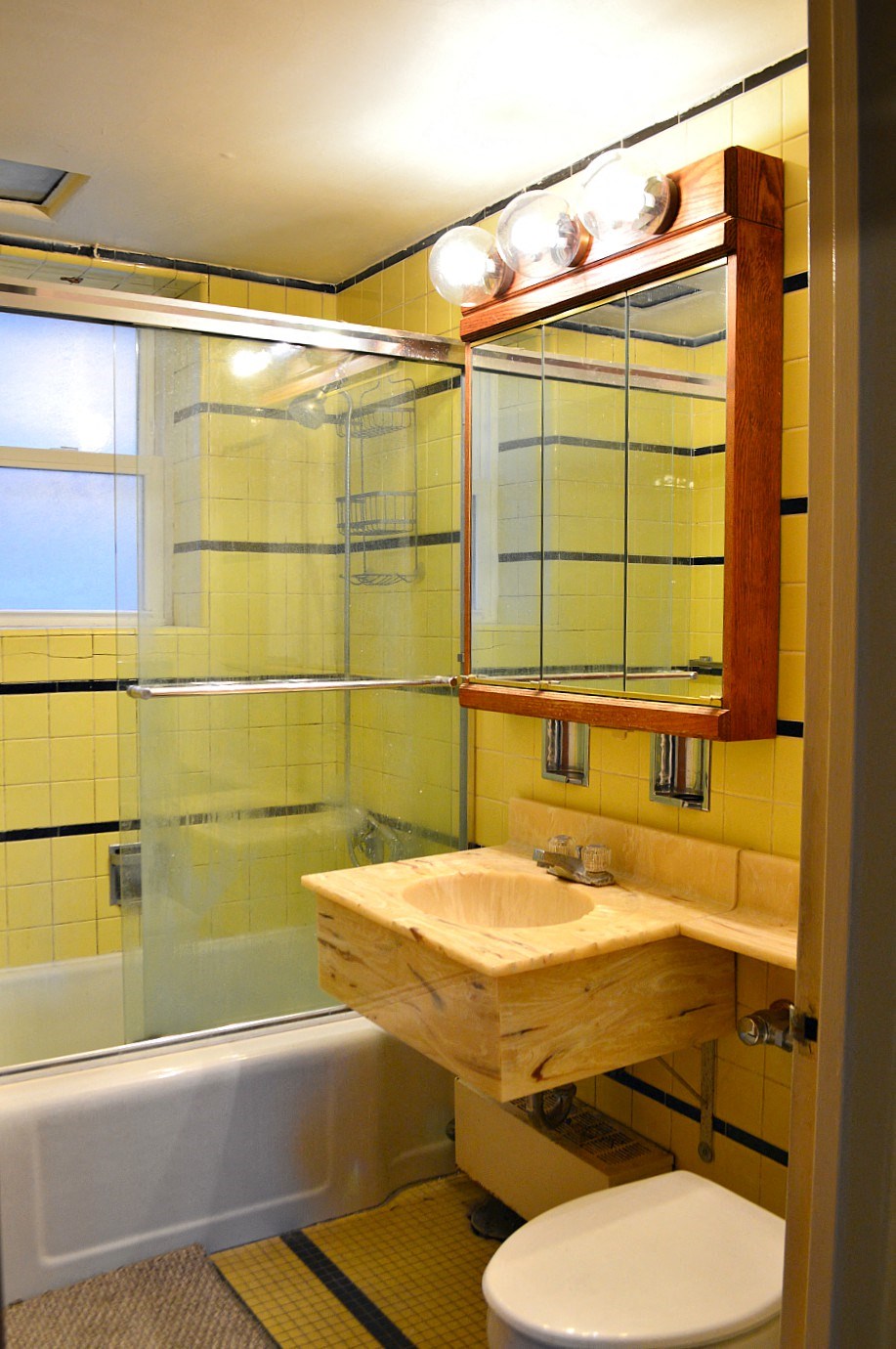 a bathroom with a toilet and a sink and a shower