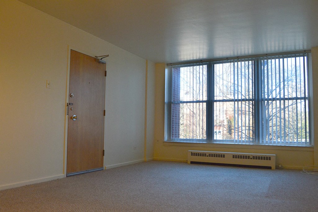 the living room of an empty house with a large window