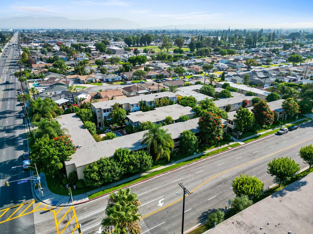 an aerial view of a neighborhood of houses on a city street