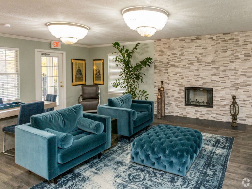 a living room with blue couches and a fireplace
