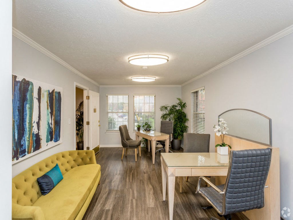 a living room and dining room with a yellow couch and a table
