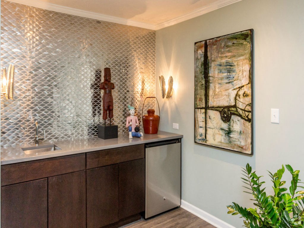 a kitchen with a counter and a painting on the wall