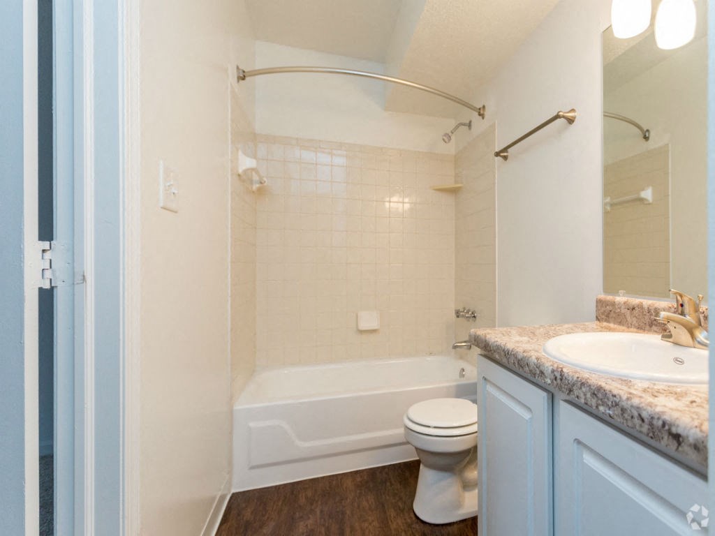 a bathroom with a sink toilet and a bath tub