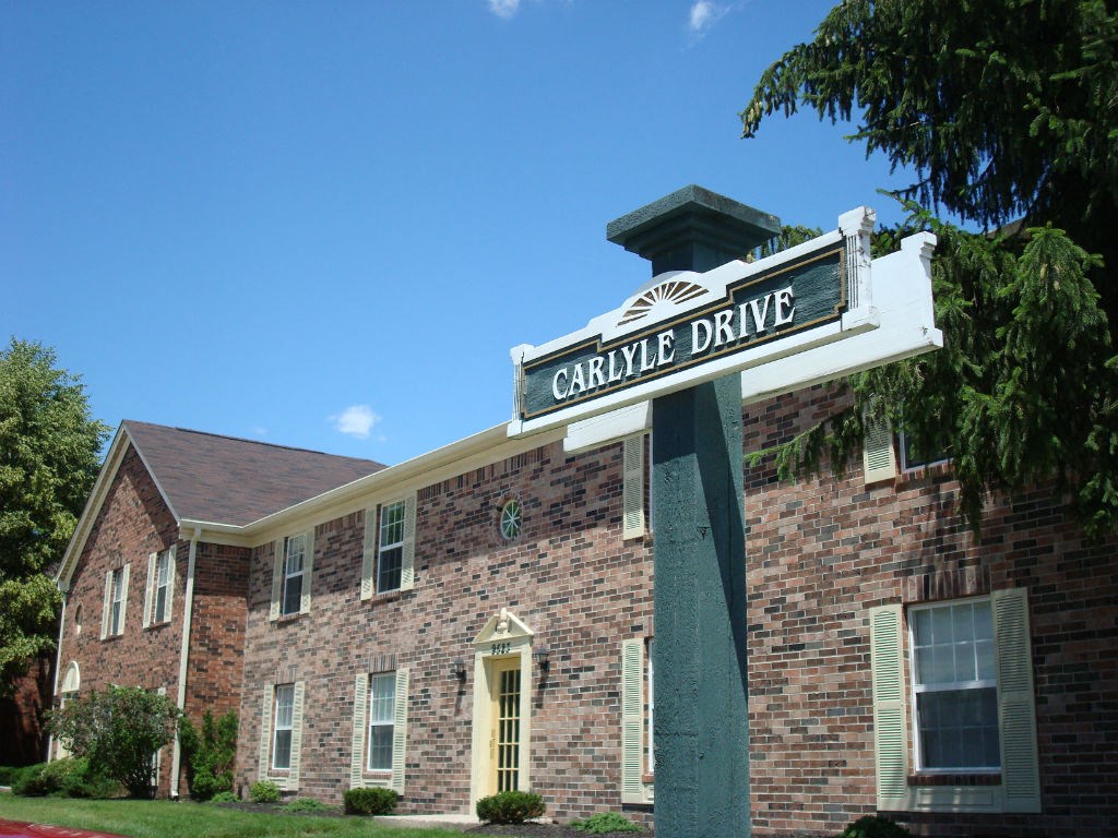a street sign in front of a brick building
