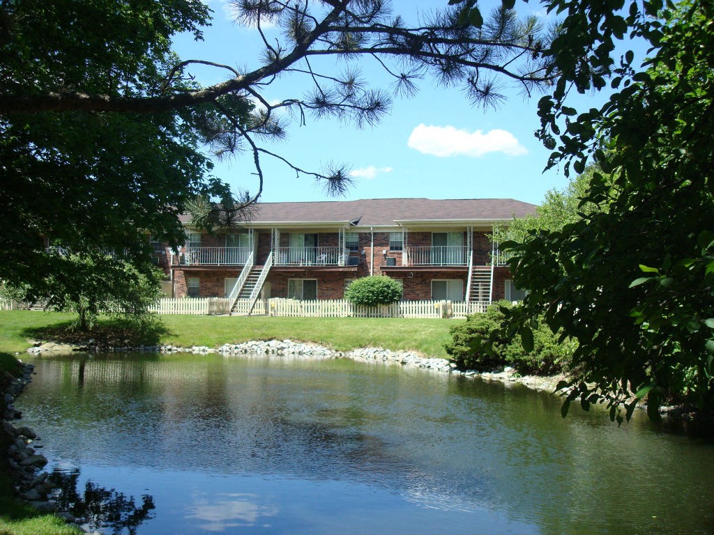 a view of the apartments from across the lake