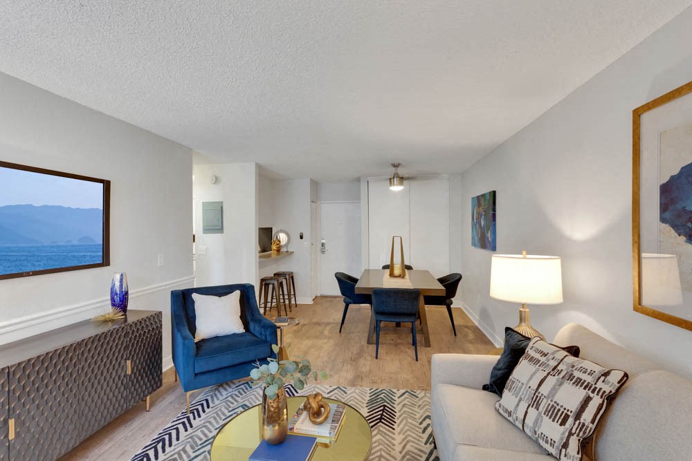 a living room and dining room with a table and chairs