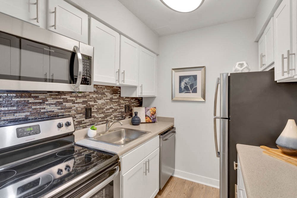 a kitchen with stainless steel appliances and a stove top oven