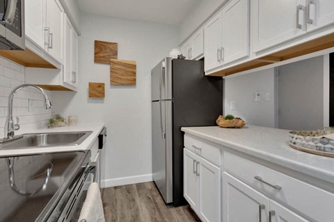 a kitchen with a sink and a refrigerator