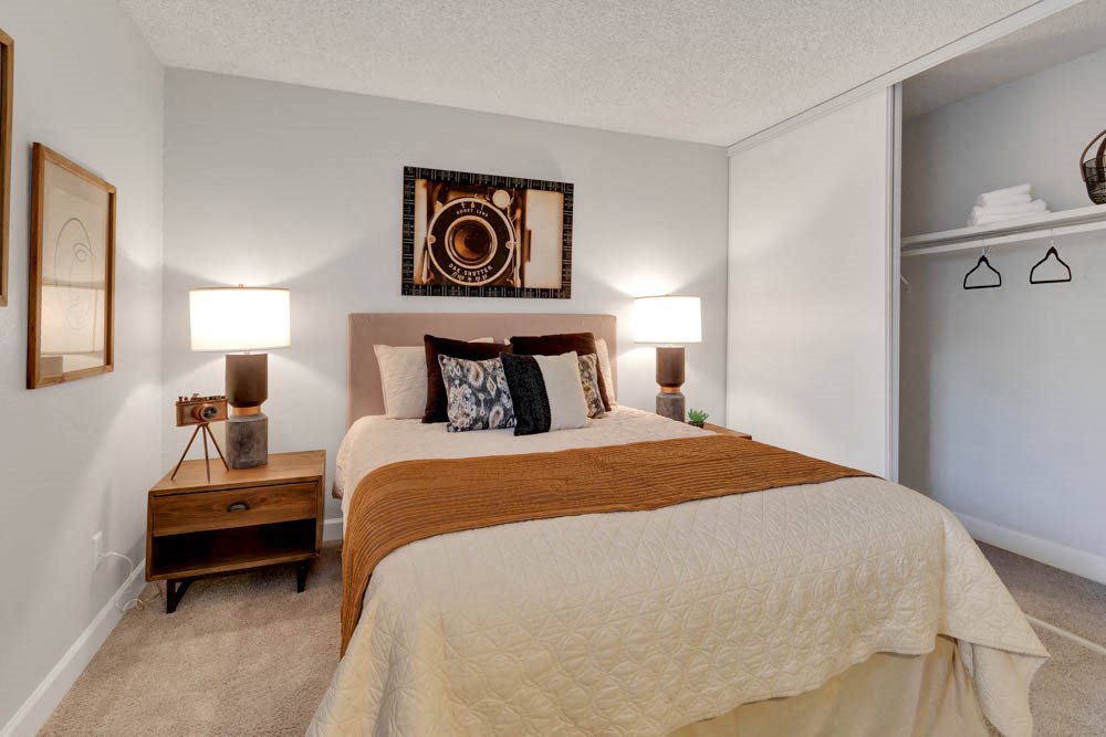 a bedroom with a bed and two lamps