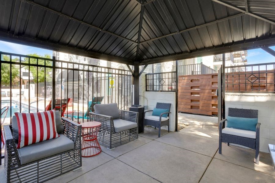 a patio with chairs and a table on a patio