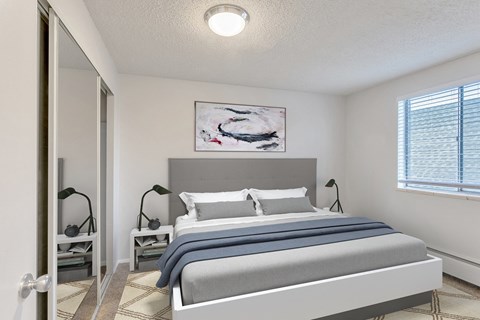 a bedroom with a large bed and a window