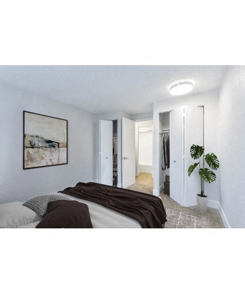 a bedroom with a bed and a potted plant