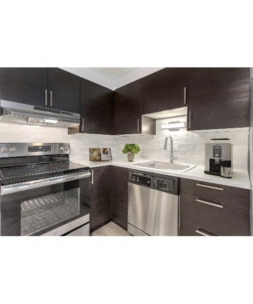 a kitchen with stainless steel appliances and black and white cabinets