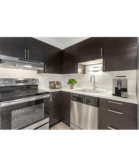 a kitchen with stainless steel appliances and black and white cabinets