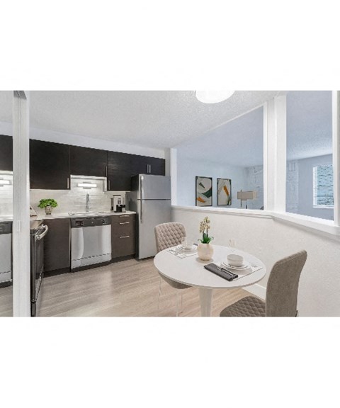 an open kitchen and dining room with a table and chairs