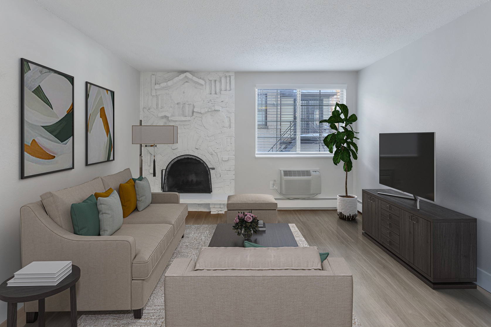 A living room with a beige couch, a coffee table, and a fireplace.