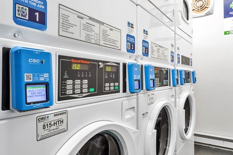 a row of washing machines in a laundromat