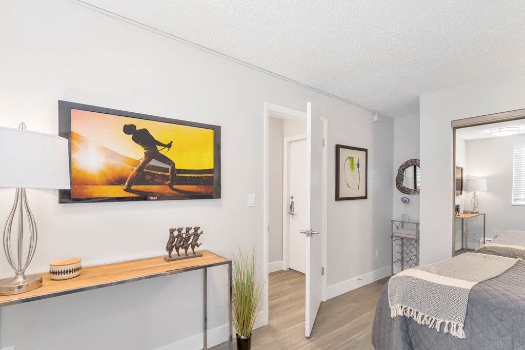 a bedroom with a bed and a painting on the wall