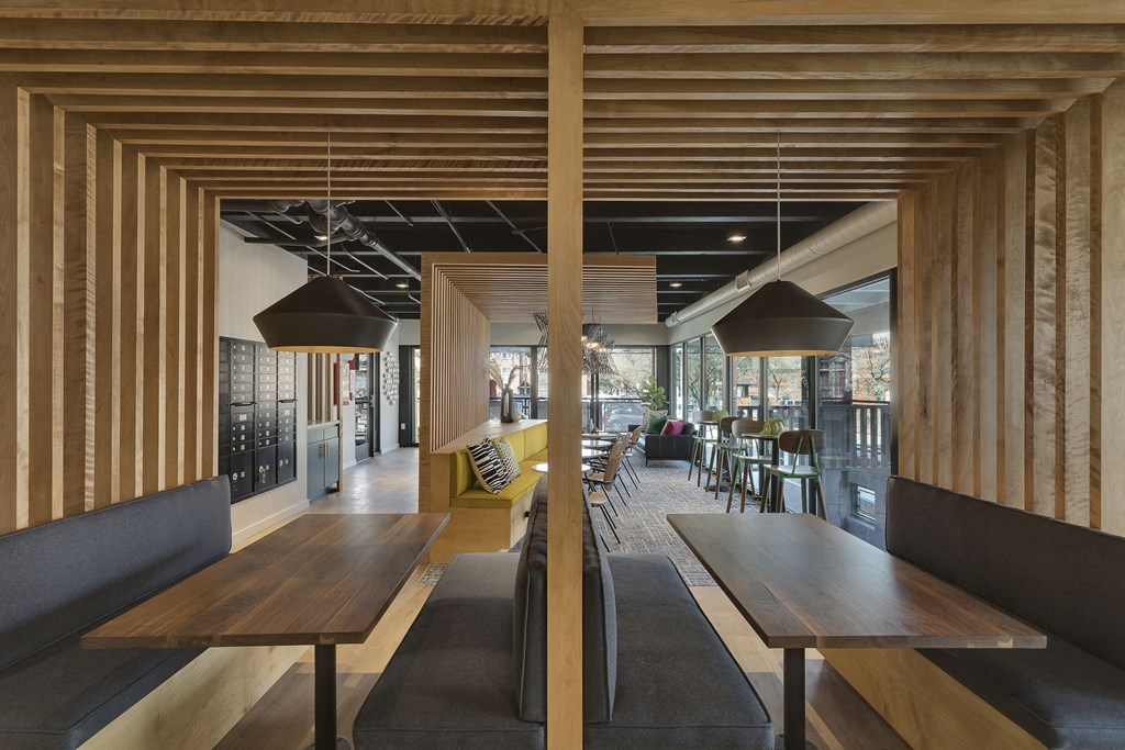the interior of a restaurant with wooden tables and chairs