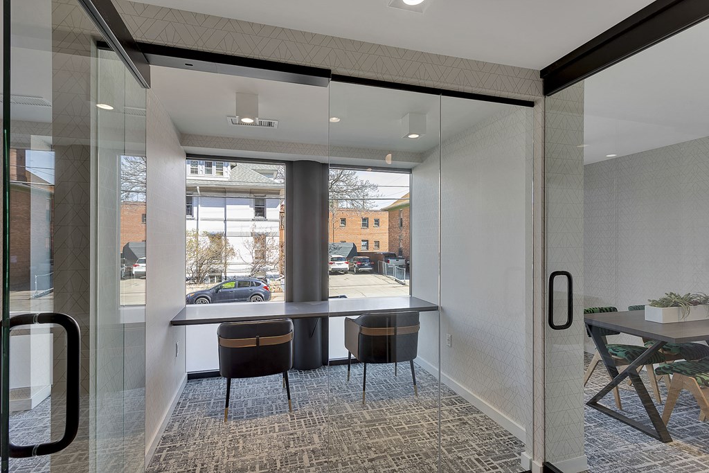 a conference room with a table and chairs in front of a window