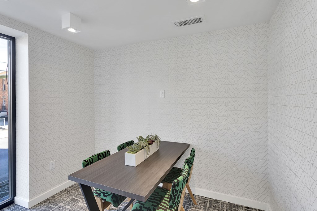 a dining room with a wooden table and green chairs