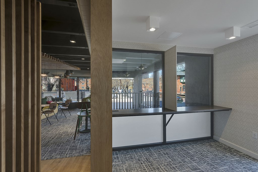 a view of a lobby with a counter and a table with chairs