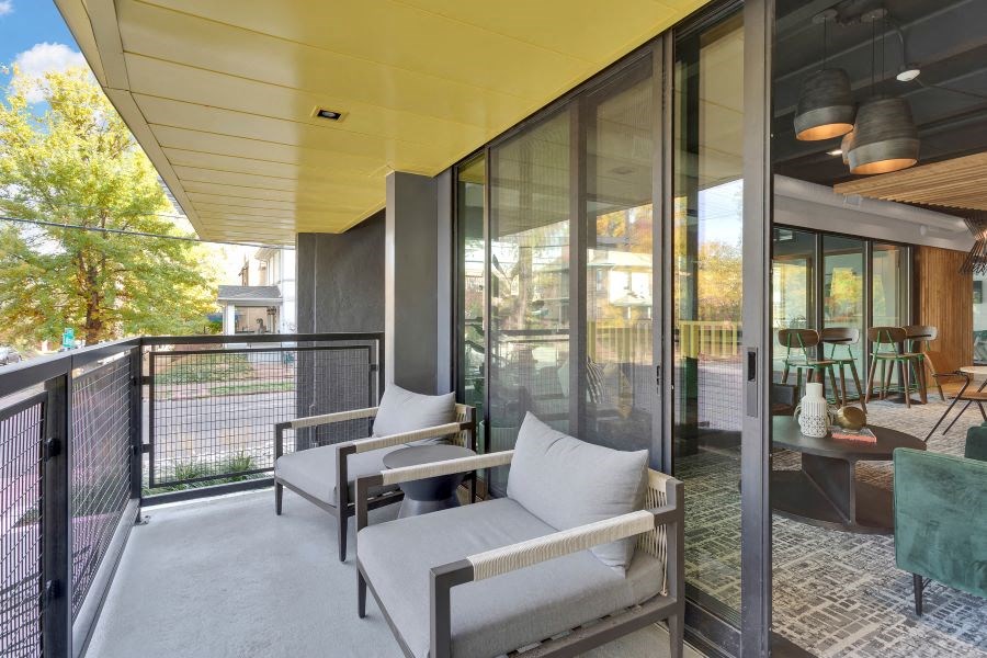 a patio with chairs and a table on a balcony