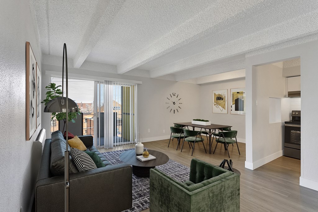 a living room with a couch and a chair and a dining table