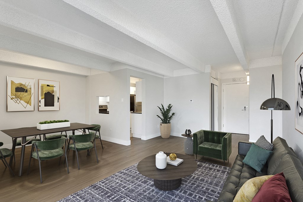 a living room and dining room with a table and chairs