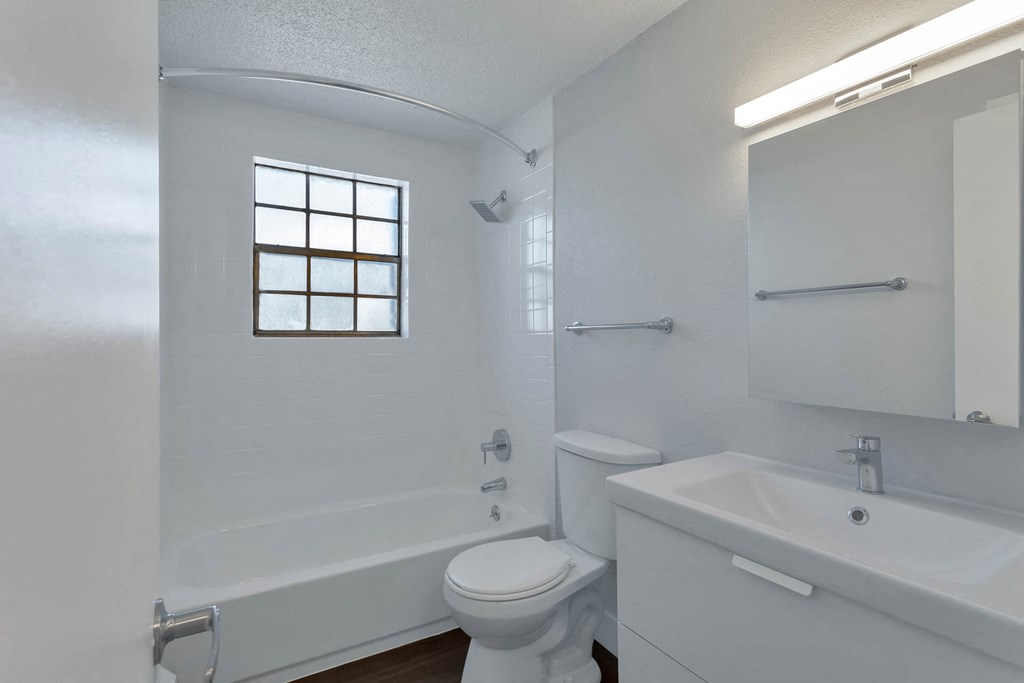 a bathroom with a sink toilet and a bath tub