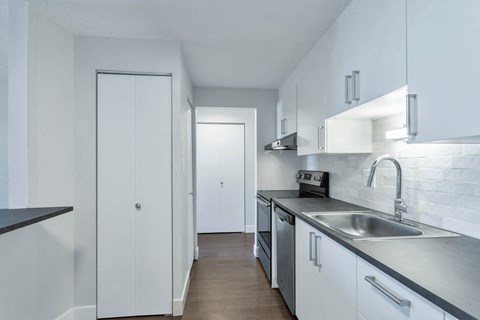 a kitchen with white cabinets and a sink
