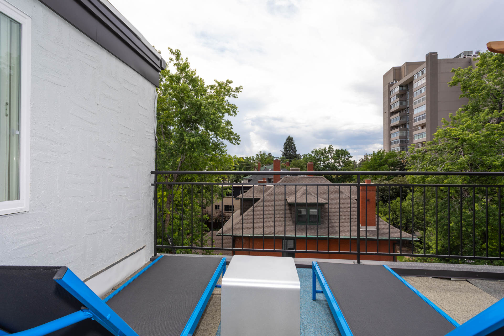 furnished balcony with table and chairs and a view of a house