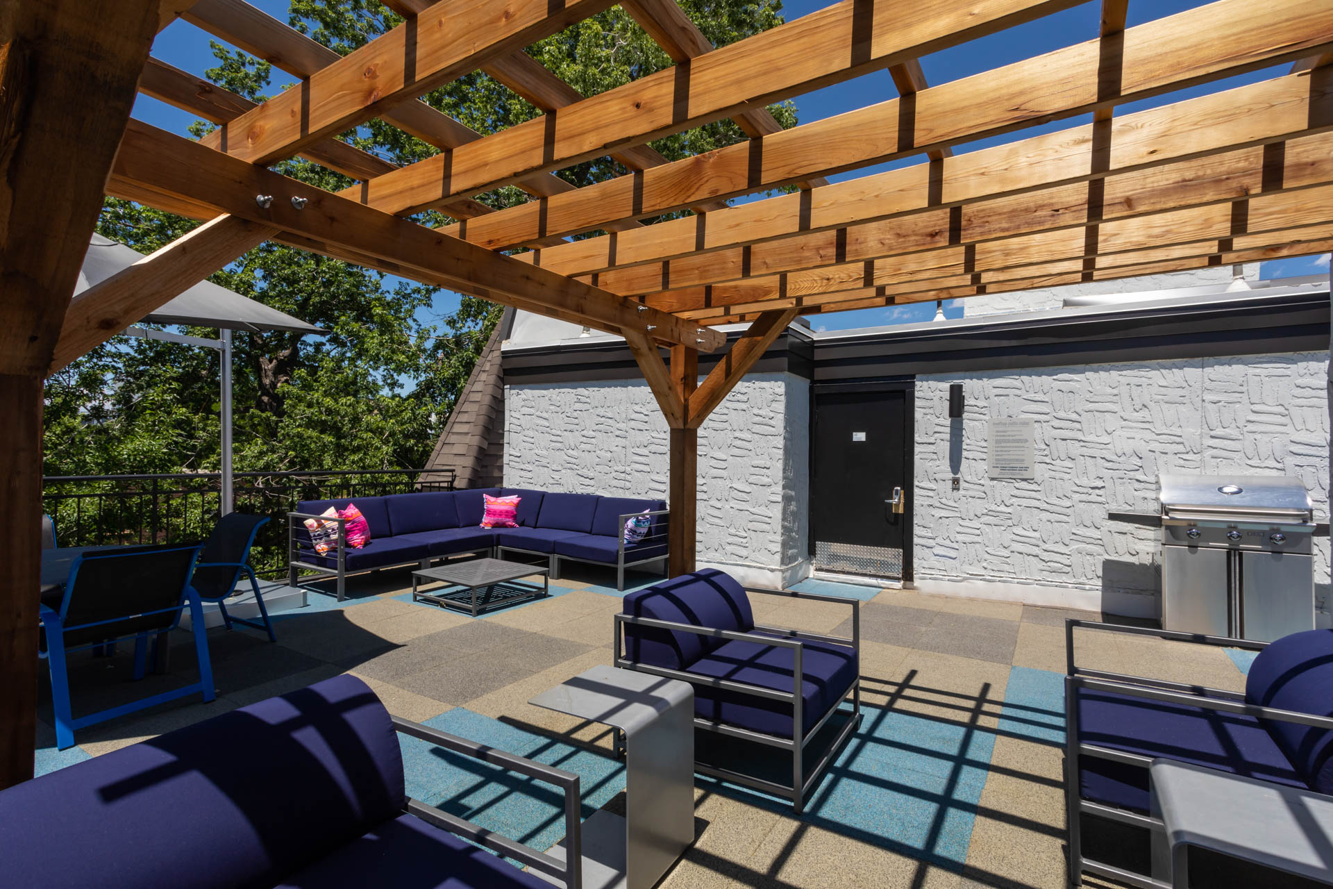 a covered patio with furniture and a grill