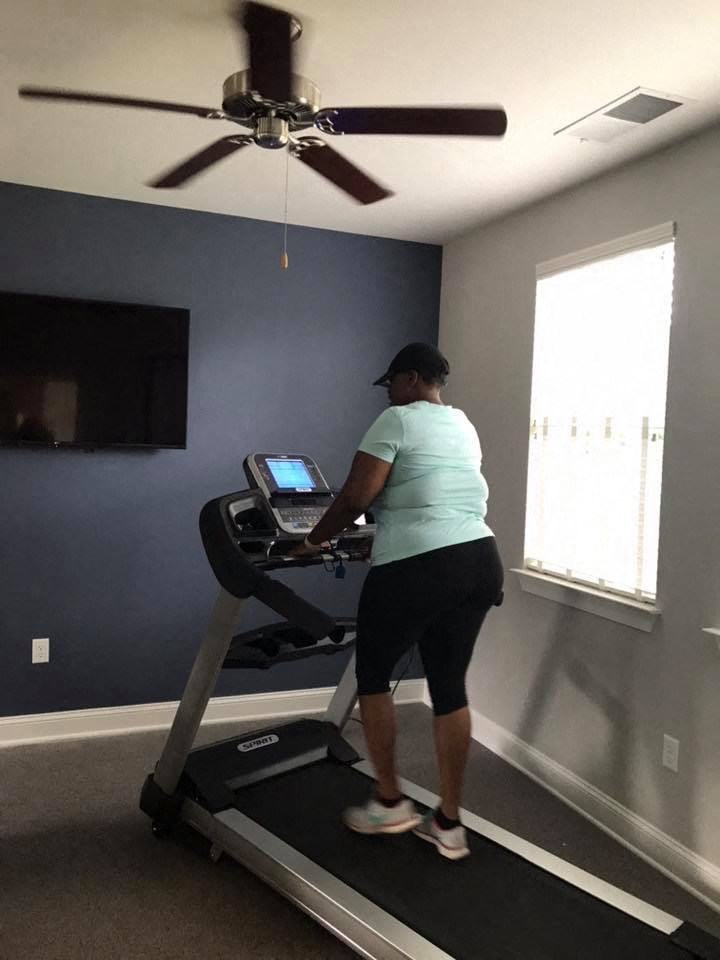 a woman running on a treadmill in a home gym