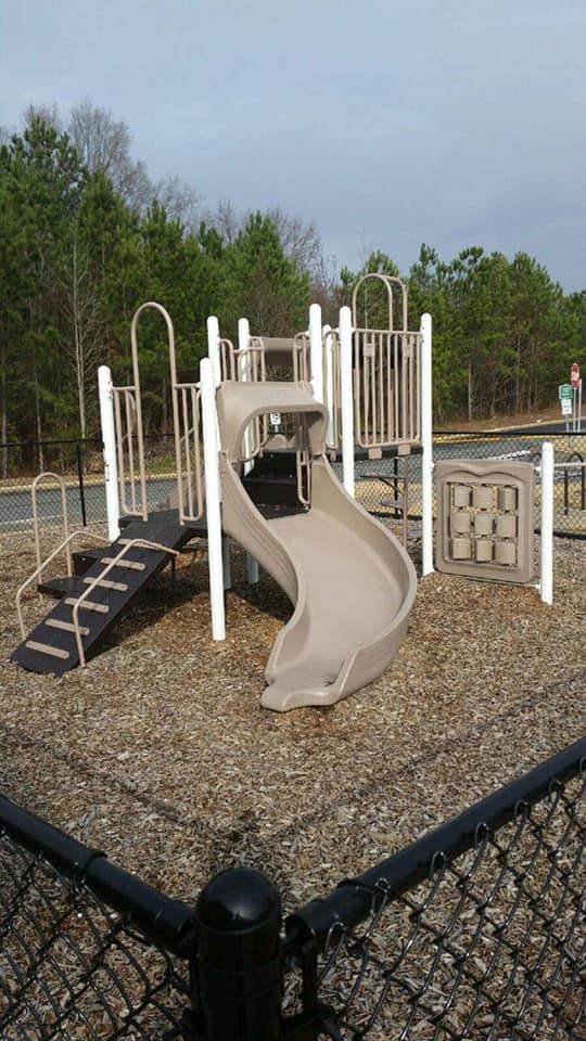 a childrens playground with a slide and climbing equipment