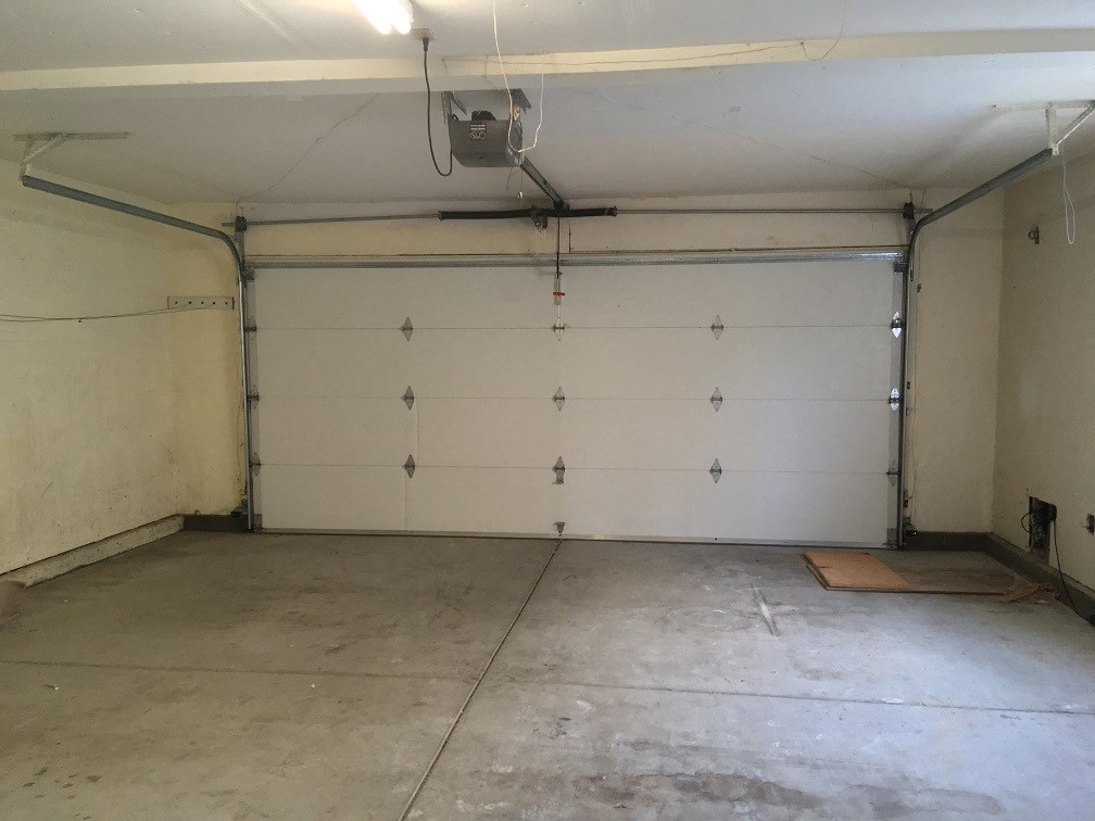 the inside of a garage with a white wall