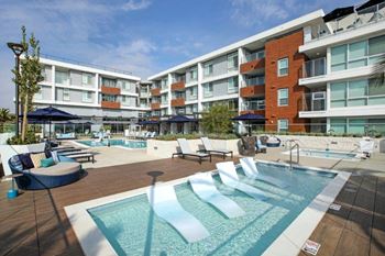 Central community paseo with direct access to the elevated pool decks