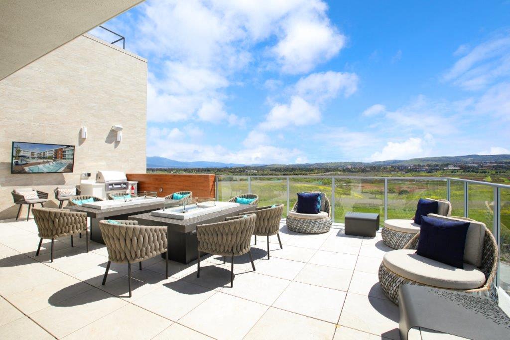 a terrace with tables and chairs and a view