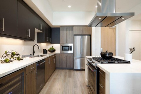 a modern kitchen with stainless steel appliances and wooden cabinets