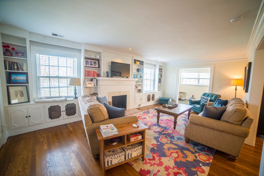 a living room with couches and chairs and a fireplace