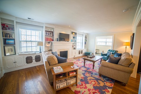 a living room with couches and chairs and a fireplace